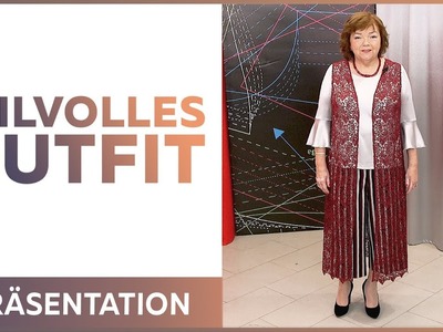 Ein Look aus gekürzter und weiter Hose einer Seidenbluse  und einer langen Spitzenweste Präsentation